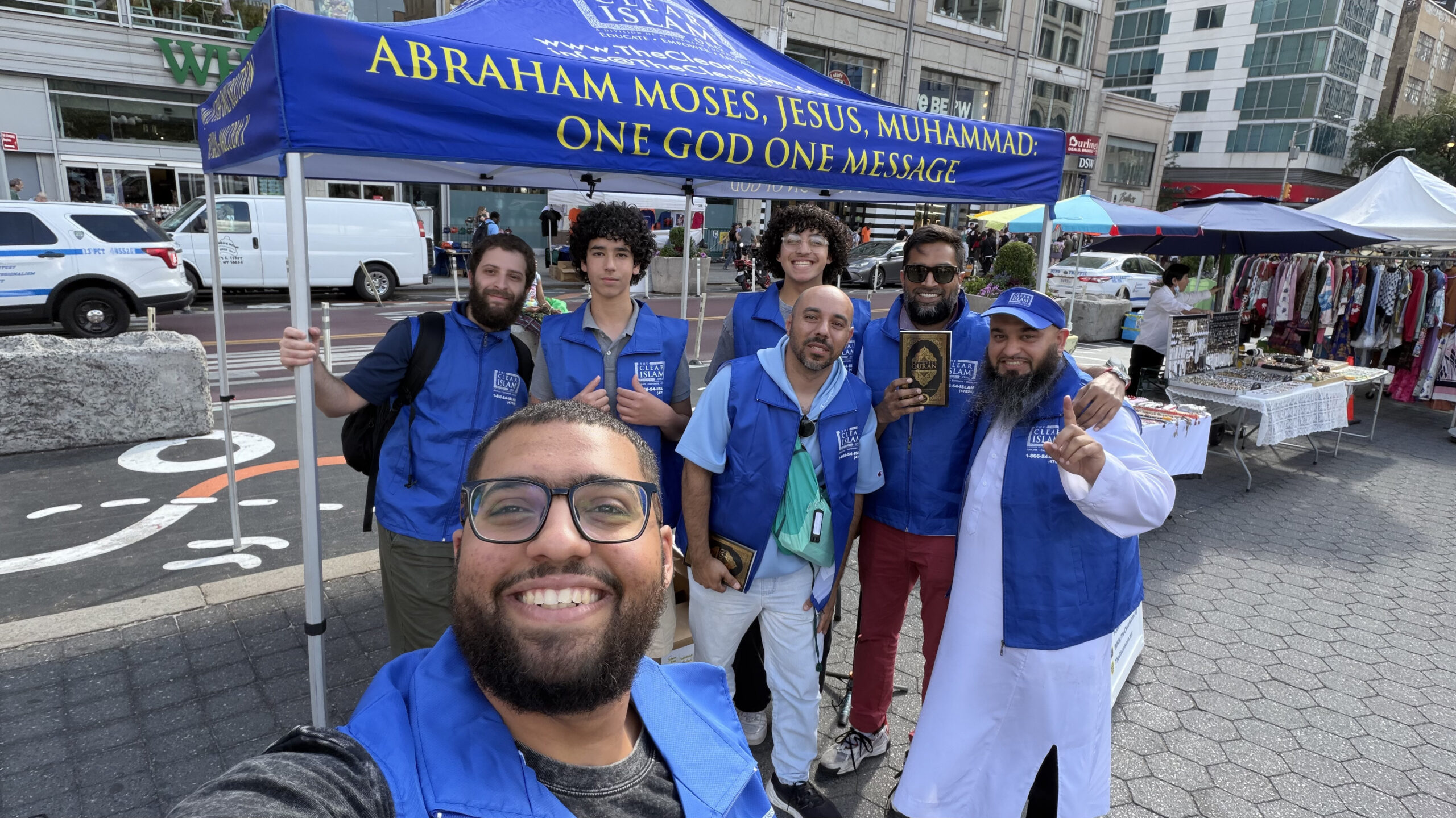The Clear Islam\u00ae volunteers speaking with a visitor at a public dawah booth